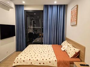 a bedroom with a bed and a window with blue curtains at Happy Home S112 in Gia Lâm Pho