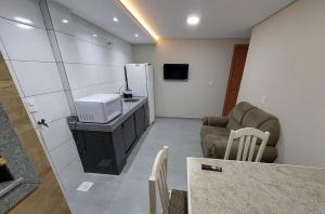 a living room with a couch and a refrigerator at Apartamento novo - 2 Quartos Casal até 4 pessoas - Centro - Santa Rosa - RS in Santa Rosa +6 photos