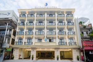 a large white building with balconies on it at Sandals Mimosa in Da Lat