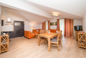 a living room with a wooden table and chairs at Apartments Schmittental - Schmitten62 Self Check-In in Zell am See