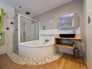 a bathroom with a tub and a sink and a mirror at Maison à Saint Denis d'Oléron - Jardin - 6 personnes - FR-1-246A-372 in Saint-Denis-dʼOléron +18 photos