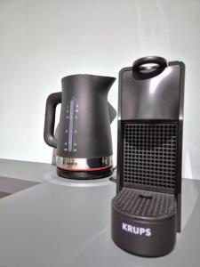 a coffee pot sitting on top of a counter at La Pigna Suites in Verona