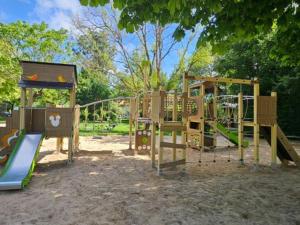 a playground with a slide in a park at Chalet avec Terrasse à Coulon, 36m², 5 personnes - API-1-52-569 in Coulon