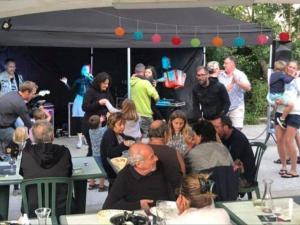a group of people sitting at tables under a tent at Chalet avec Terrasse à Coulon, 36m², 5 personnes - API-1-52-569 in Coulon +27 photos
