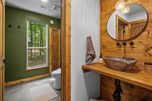 a bathroom with a sink and a mirror at LostForest Cabins in Richards +164 photos