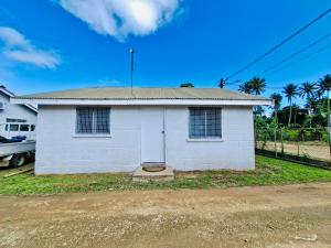 a small white house with a roof at Pearl Cottage - 2 Bedroom Entire Place in Nuku‘alofa