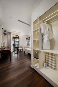 a room with a living room with a couch and a table at Jade Boutique Hotel in Hanoi