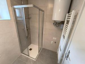 a shower with a glass door in a bathroom at Apartma Mirko in Bovec +23 photos