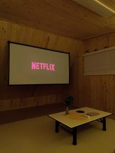 a screen with a netflix sign on a wall at Shiny Picnic in Seoul +33 photos