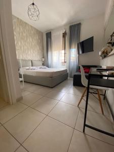 a bedroom with a bed and a tiled floor at B&B 30 mt dal Duomo in Benevento +42 photos