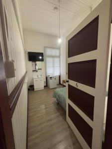a room with a door leading to a bedroom at The Australian Hotel Gympie in Gympie