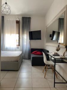 a bedroom with a bed and a desk and a bed and a desk at B&B 30 mt dal Duomo in Benevento