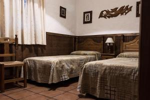 two beds in a room with two at Complejo Vacacional Los Cortijillos-Solo adultos in Conil de la Frontera