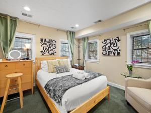 a bedroom with a bed and a chair and windows at Washington, DC's Finest Address in Washington