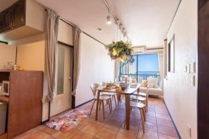 a kitchen and dining room with a table and chairs at Cute&Resort熱海 in Atami
