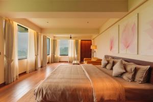 a bedroom with a large bed in a room at THE EDGE Kasauli in Kasauli +55 photos