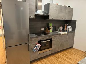 a kitchen with a stainless steel refrigerator and a stove at Ferienwohnung Galli in Gallneukirchen