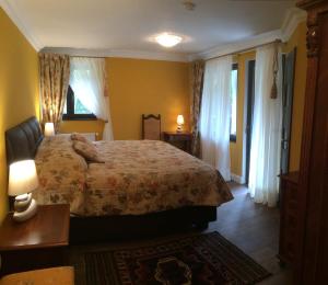 ソコロフにあるHunting Lodge Vitkovのベッドルーム1室(ベッド1台、ランプ2つ、窓付)