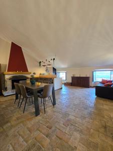a living room with a table and chairs and a fireplace at The Pendulum in Orte