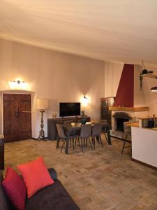 a living room with a table and a fireplace at The Pendulum in Orte