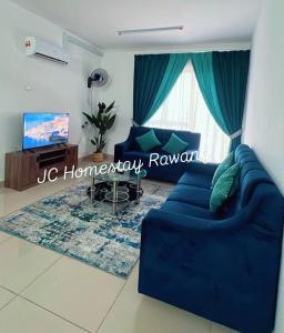 a living room with a blue couch and a tv at JC HOMESTAY PARADiSE in Rawang