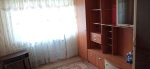 a living room with a window and a television at Квартира 2х-комнатная посуточно in Kryvyi Rih