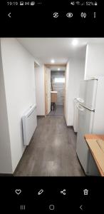 an empty kitchen with a refrigerator and a table at Chambres d'hôtes en Alsace in Sélestat +8 photos