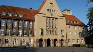 a building with a clock on the side of it at City Hotel in Delmenhorst