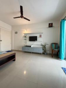 a living room with a flat screen tv on a wall at Home Stay 1 BHK Apartment Electronic City -Oakwood in Attibele