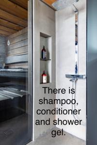 a kitchen with a door with the words there is shampoo and shower gel at Luxury guesthouse, beachfront sauna in Jyväskylä +24 photos