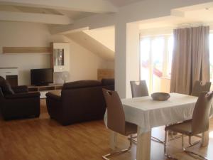 a living room with a white table and a couch at Apartments Jelicic in Selce