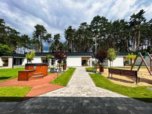 a park with benches and trees and a building at LABA Wieleń in Wielen Zaobrzanski