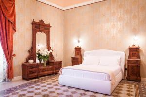 Posteľ alebo postele v izbe v ubytovaní Palazzo Montalbano