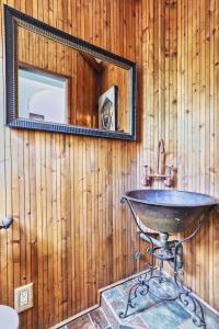 a bathroom with a sink and a mirror at Heated Poolhistoric Tudor Homecrestmere Estate in Memphis