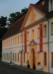 a building with red signs on the side of it at Hotel Tynec in Týnec nad Sázavou
