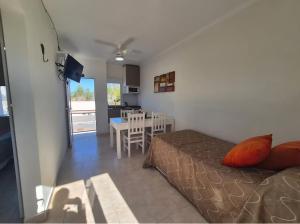 a living room with a bed and a dining room at Resort Termal Chajarí in Chajarí