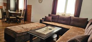 a living room with a couch and a table at Durmitor Panorama Lodge in Junčev Do