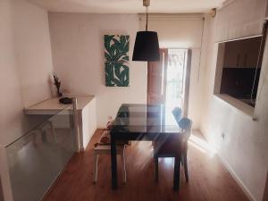 a dining room with a glass table and a chair at Casa del Valle Encantado in Galaroza