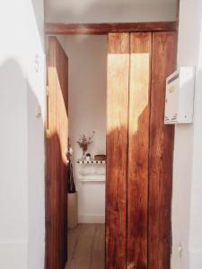 an open wooden door in a room with a stove at Casa del Valle Encantado in Galaroza