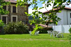 un grupo de sillas en el patio de una casa en Hotel Termas de Liérganes, en Liérganes