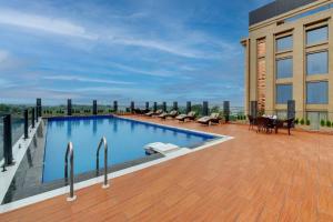 a swimming pool on the roof of a building at Rajawat The Fern - An Ecotel Hotel, Kanpur in Binaur