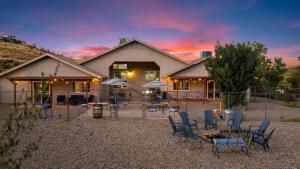 a house with chairs and a fence in front of it at Lynx Lake Lux 6-br Housesleeps 22hot Tubgame Rm in Prescott