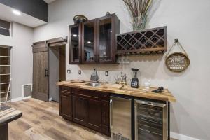 a kitchen with wooden cabinets and a counter top at Lynx Lake Lux 6-br Housesleeps 22hot Tubgame Rm in Prescott +87 photos