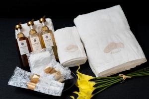two towels and two bottles of soap and some flowers at BON Osaka Namba East in Osaka +10 photos