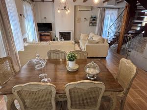 a living room with a wooden table and chairs at Marilu's port mansion house in Gaios