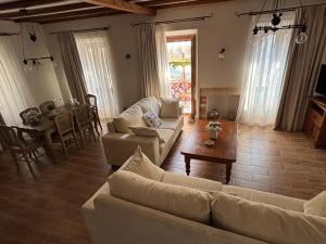 a living room with couches and a table and a dining room at Marilu's port mansion house in Gaios
