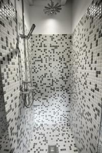 a bathroom with a tiled shower with a fan at Villas San Roque Isla in Isla +55 photos