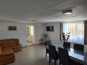 a living room with a table and a couch at Margareta's House - Free Parking, Garden, Near Sibiu in Sibiu