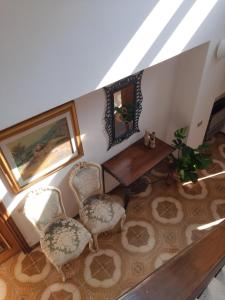 a dining room with a table and two chairs at La Maison Verte in Formia