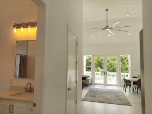 a kitchen and dining room with a ceiling fan at Silver Palms - Brand New Designer Home on Banks Road home in North Palmetto Point +22 photos